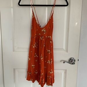A orange floral flowy dress.
